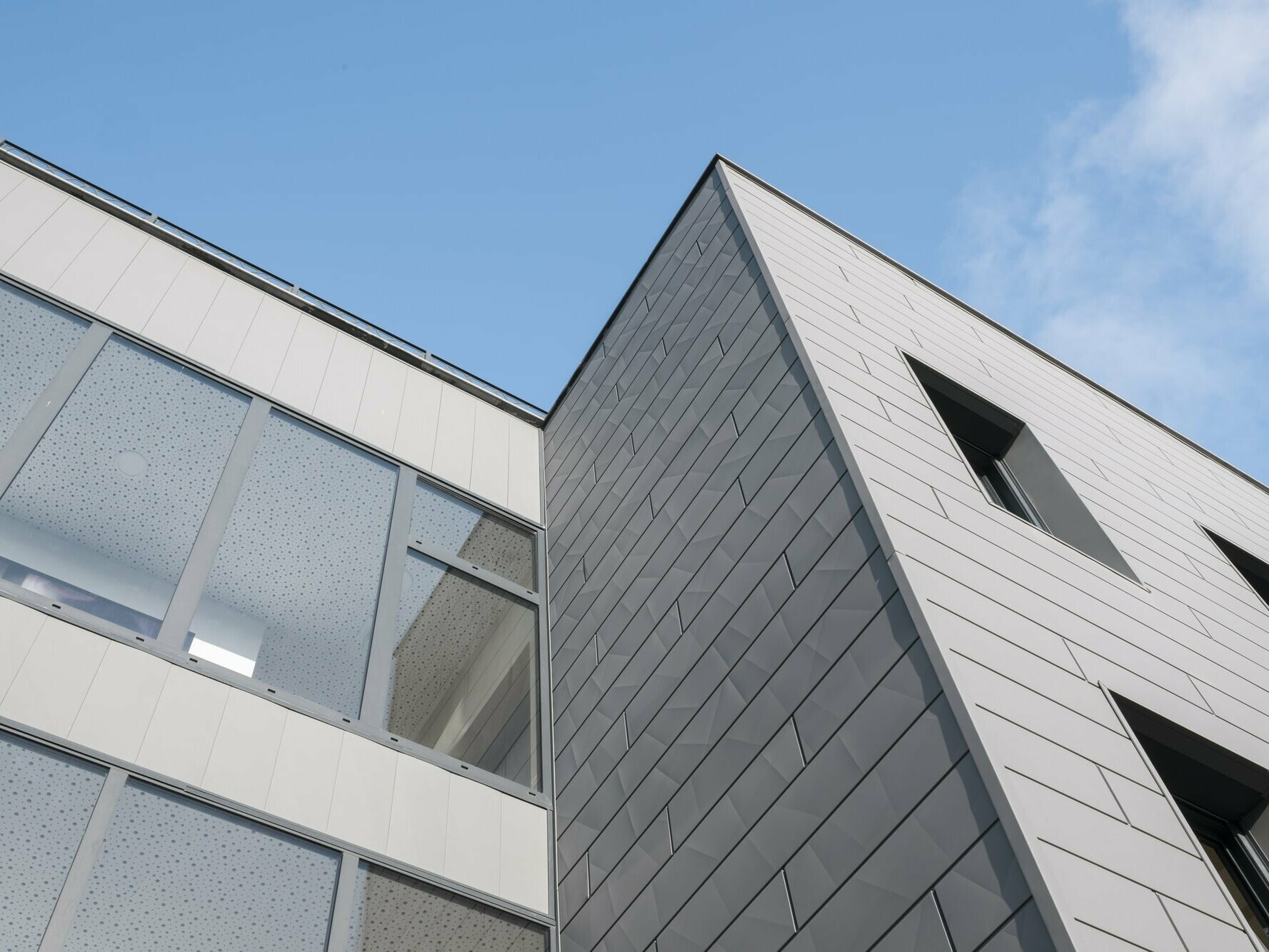 Vue du bas de l'immeuble résidentiel L'Iris dont la façade est habillée de Siding.X en aluminium PREFA