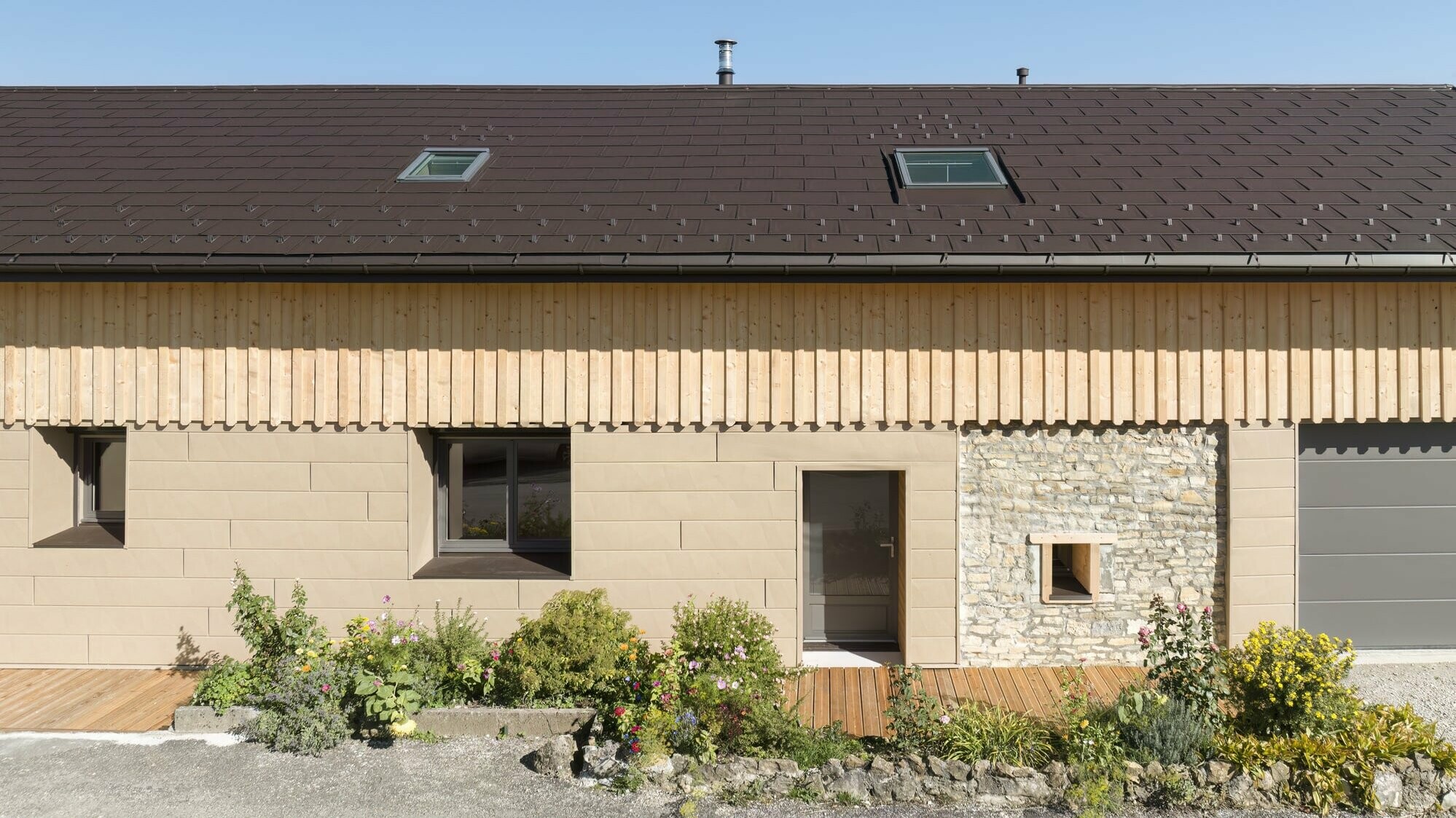 Photo d'ensemble de cette maison individuelle récemment rénovée à l'aide de plusieurs produit PREFA : le R.16 pour la couverture et le Siding.X pour la façade